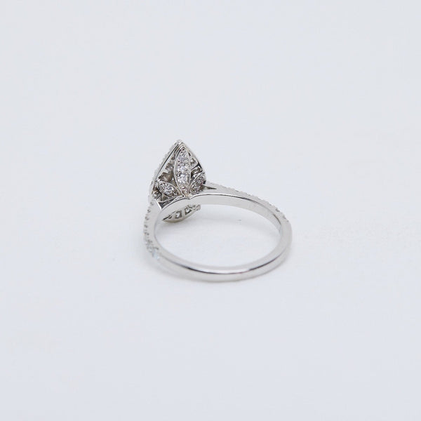 Pear diamond halo ring. Hidden diamond flower gallery.