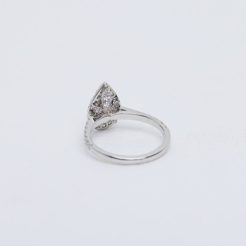 Pear diamond halo ring. Hidden diamond flower gallery.