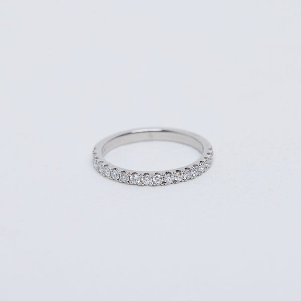 Round brilliant diamond band, split claw setting in platinum