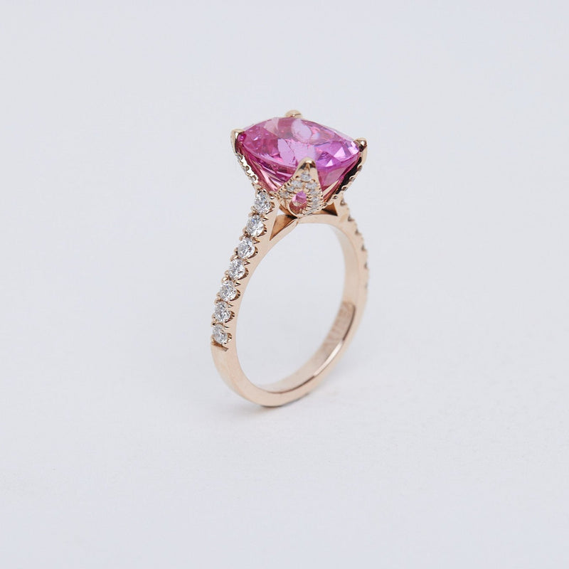 Pink oval sapphire Fleur ring with diamond set band in rose gold.