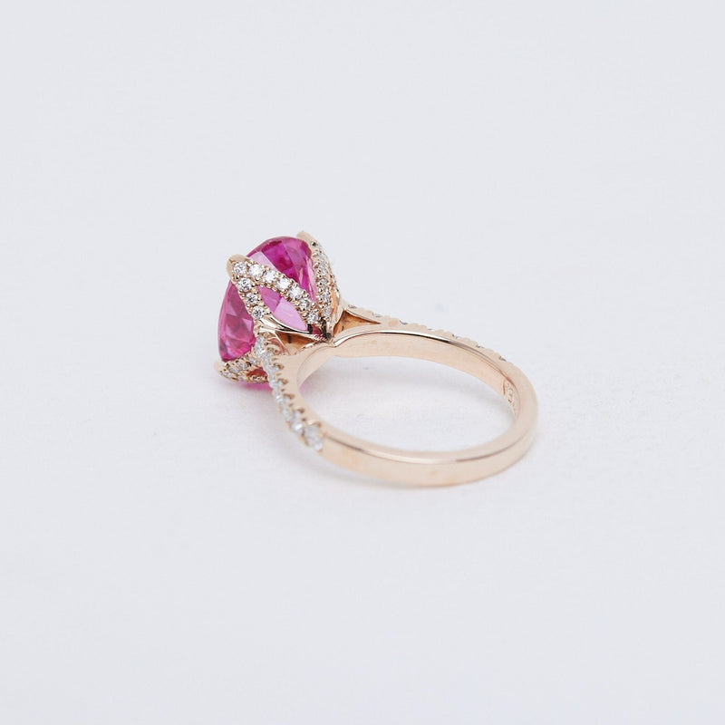 Pink oval sapphire Fleur ring with diamond set band in rose gold.